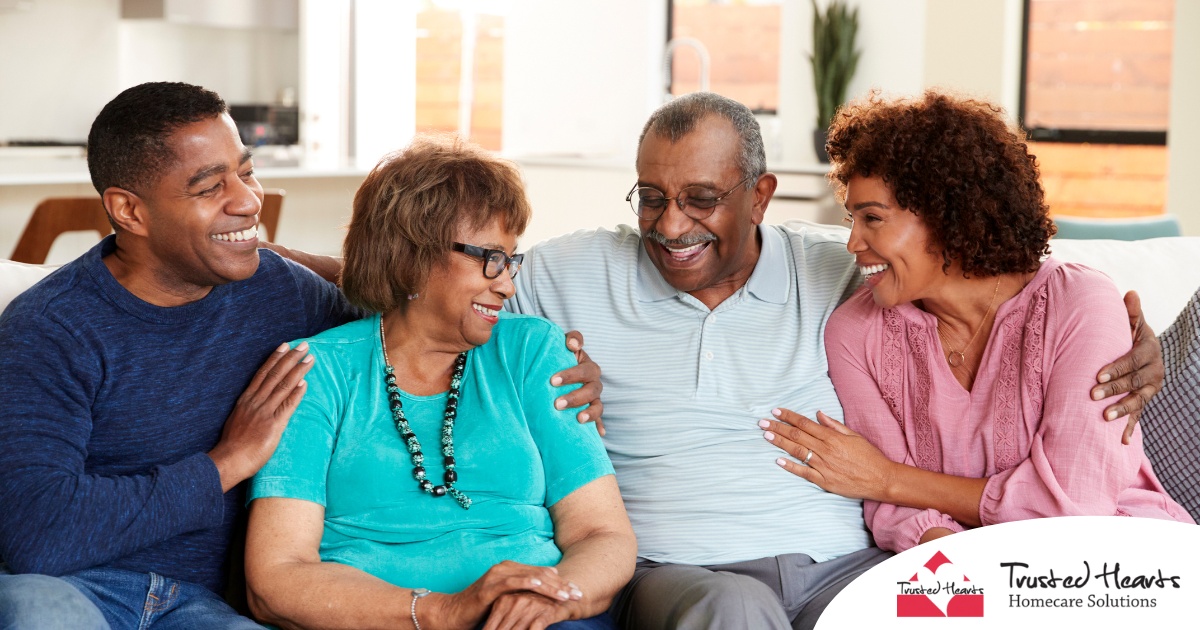 A couple sits with aging parents and enjoys their time together.