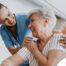 A female caregiver helping an older woman with stroke recovery at home.